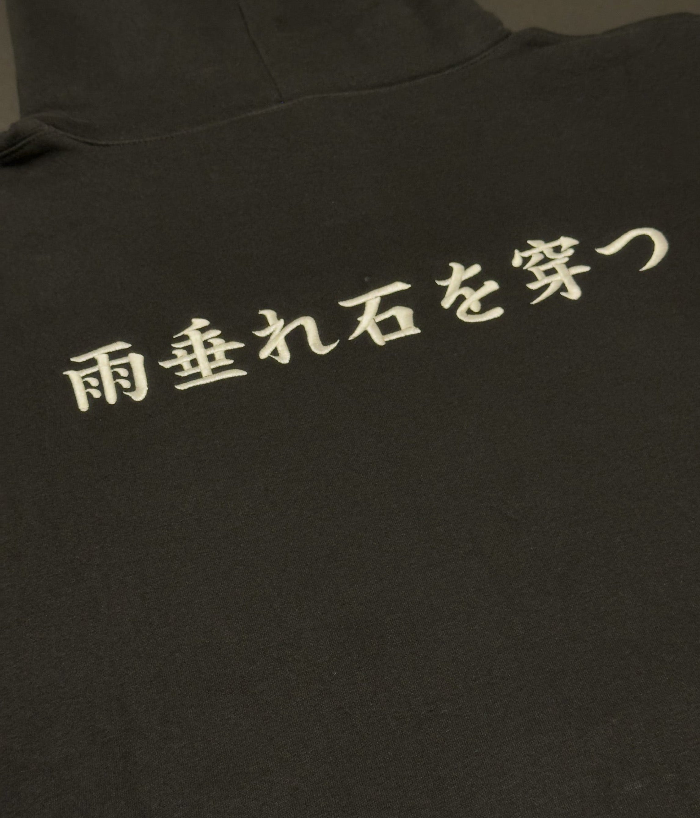 Black hoodie with 'Amadare ishi o ugatsu' on the back
