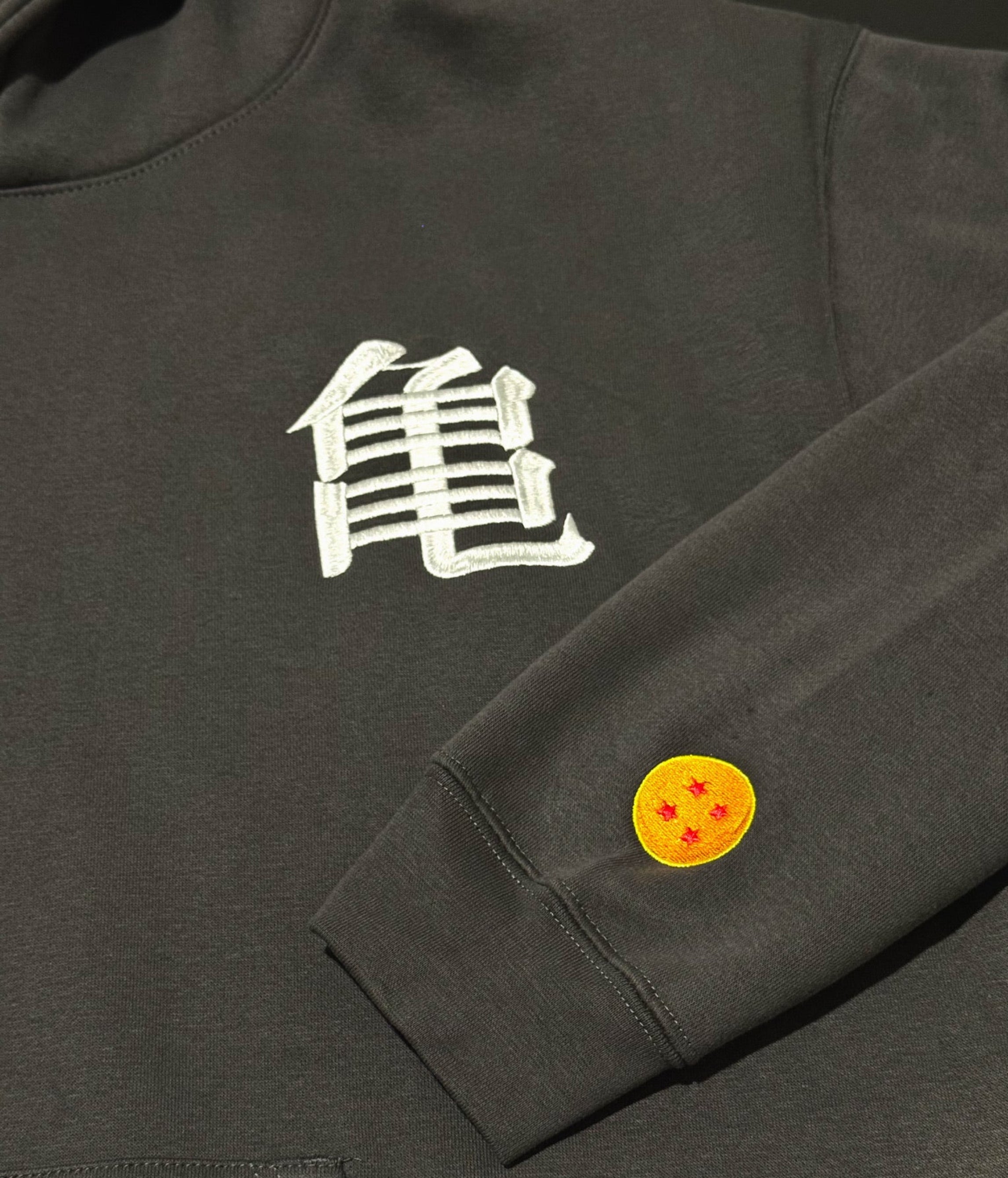 Shadow hoodie with a 'Kame' logo on the chest and Dragonball on sleeve