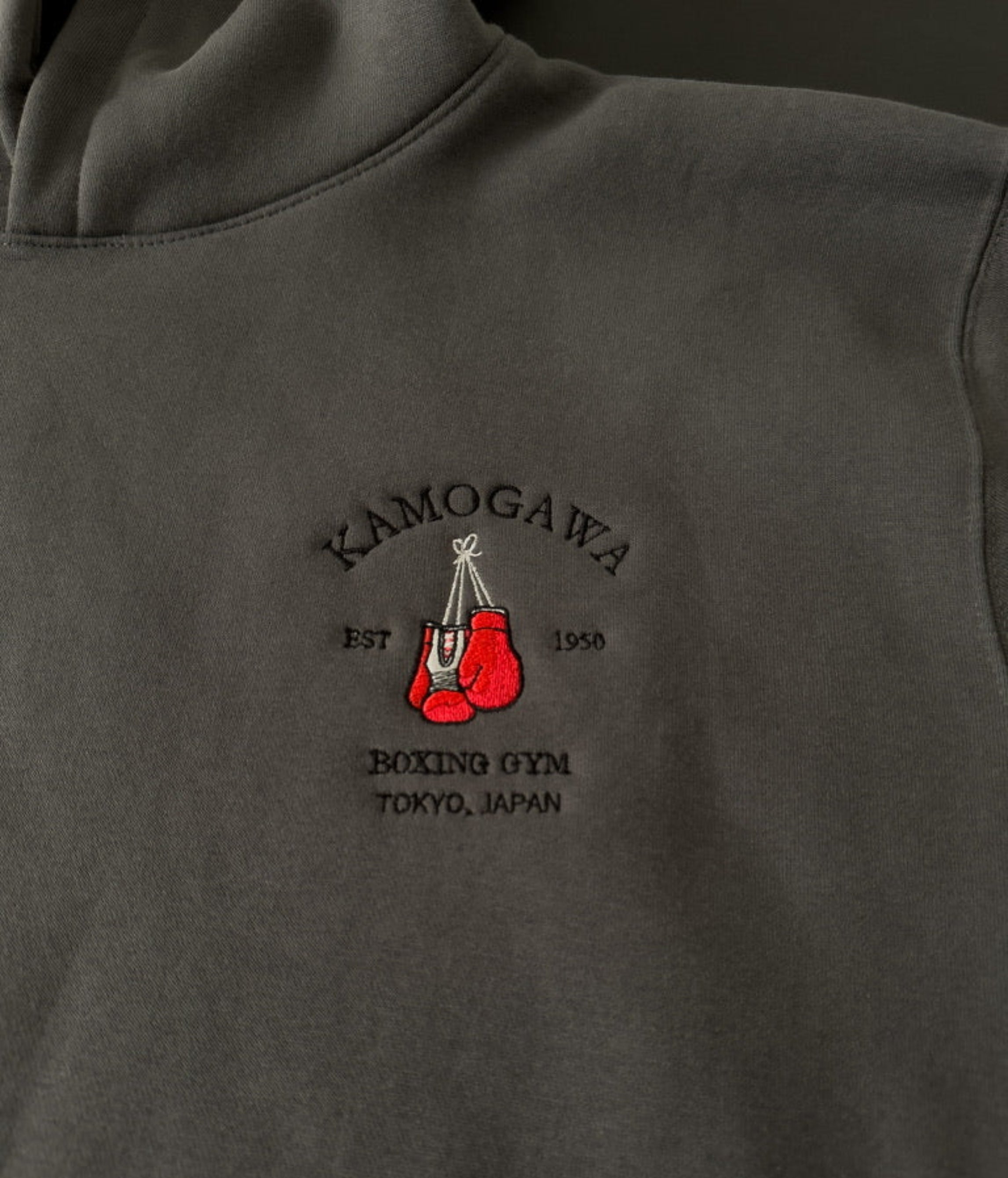 Shadow hoodie with a boxing gloves and ‘Kamogawa Boxing Gym’ on the chest