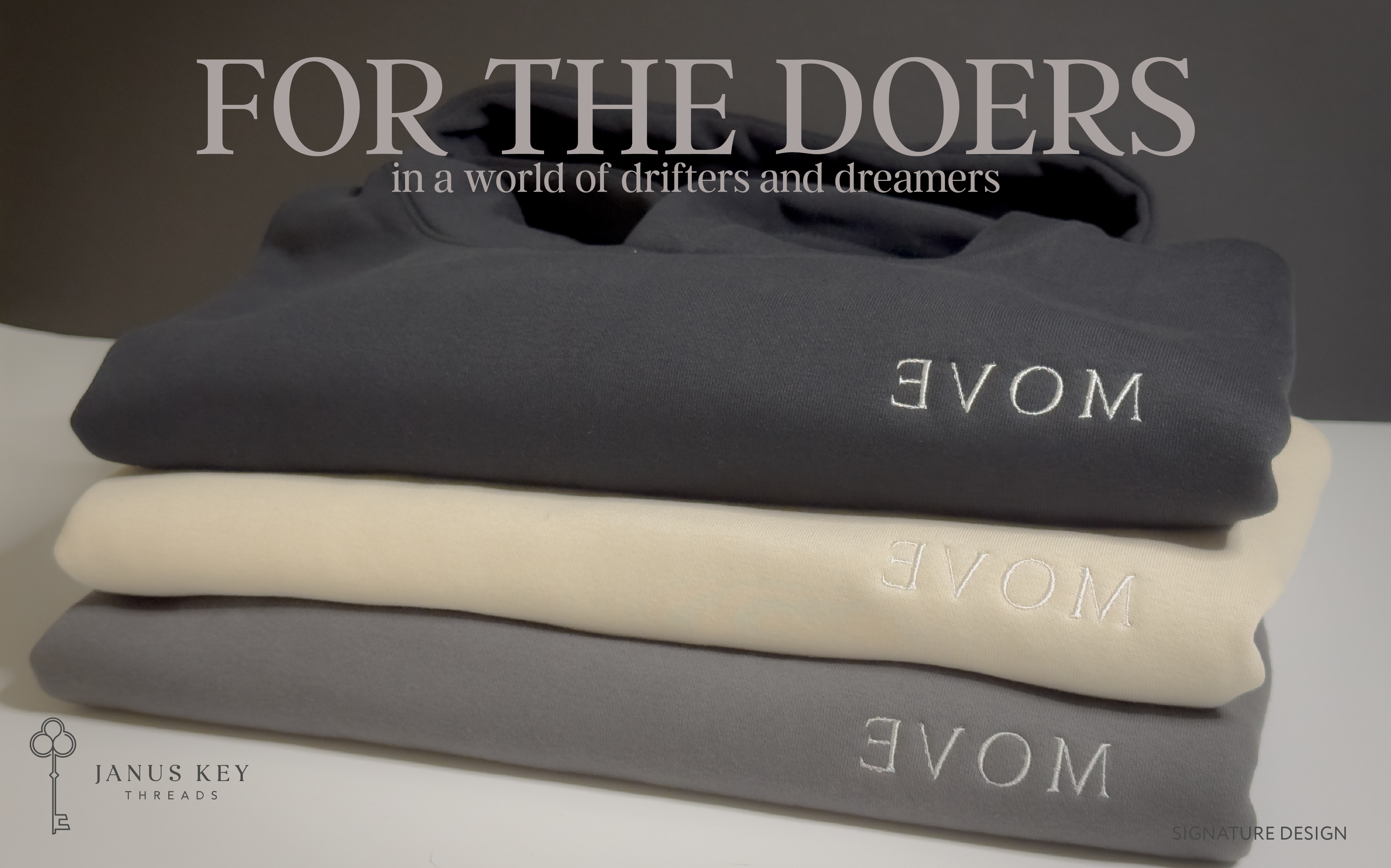 Stack of folded sweatshirts with 'MOVE' branding on a neutral background